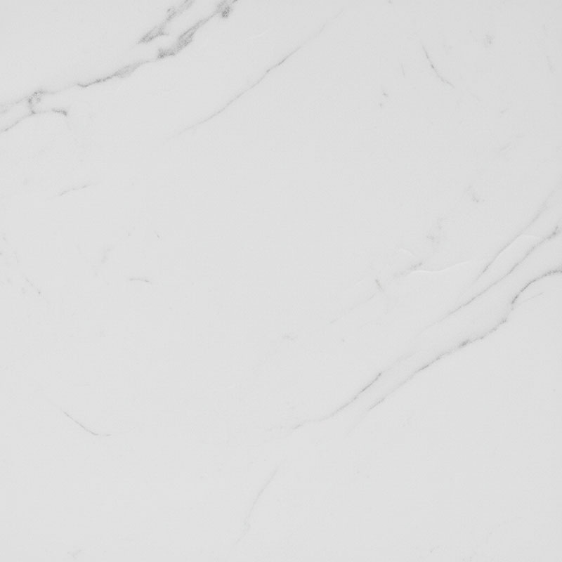 Close-up photograph of honed matte engineered quartz surface showing soft satin texture with gentle Statuario marble veining pattern