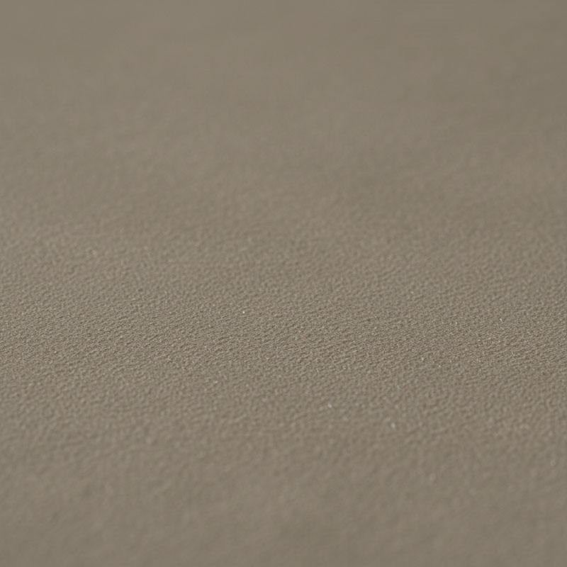 Close-up photograph of leathered textured engineered quartz surface in warm grey color showing tactile brushed texture with light catching surface undulations