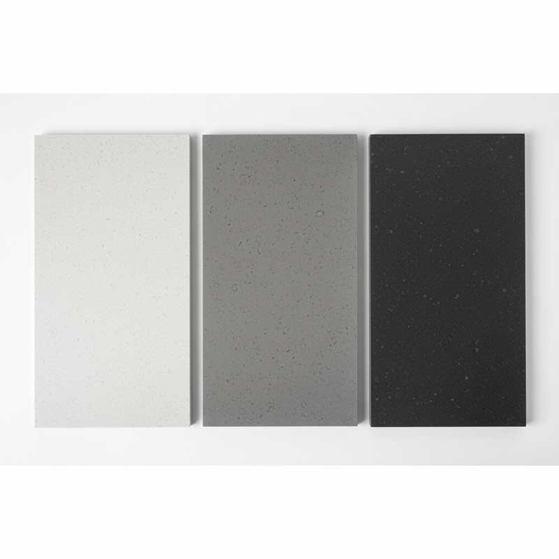 Concrete-Look Quartz Stone Color Range in Three Grey Shades Three concrete-look engineered quartz stone samples in light medium and dark grey showing matte finish color range options